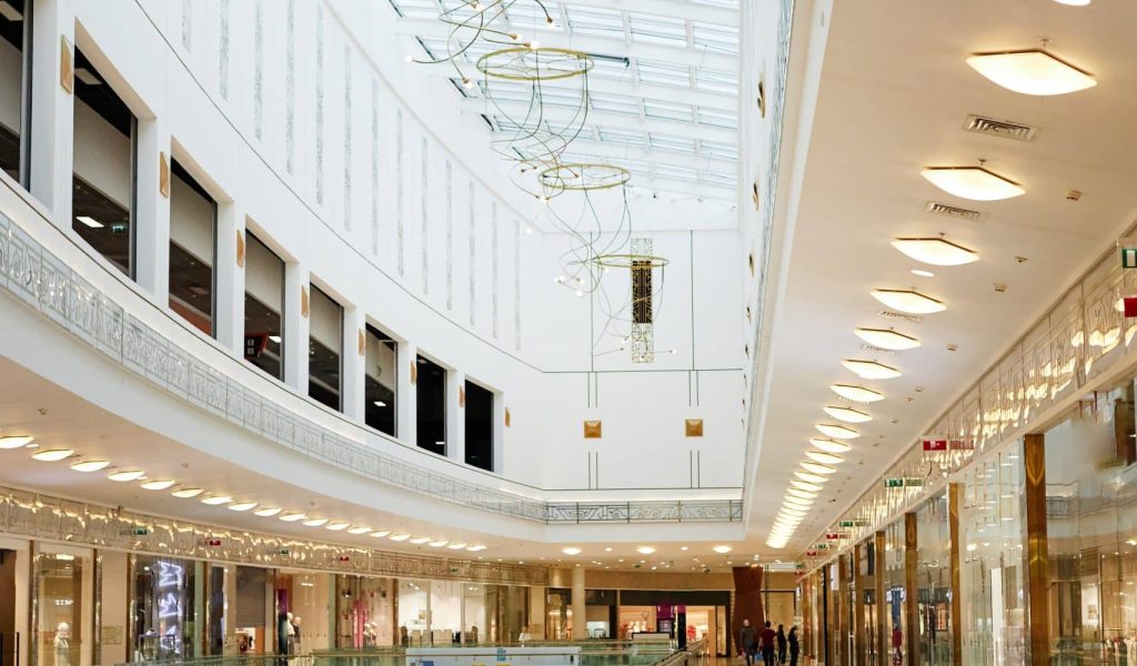 Second floor of fashionable mall decorated with lights and glass